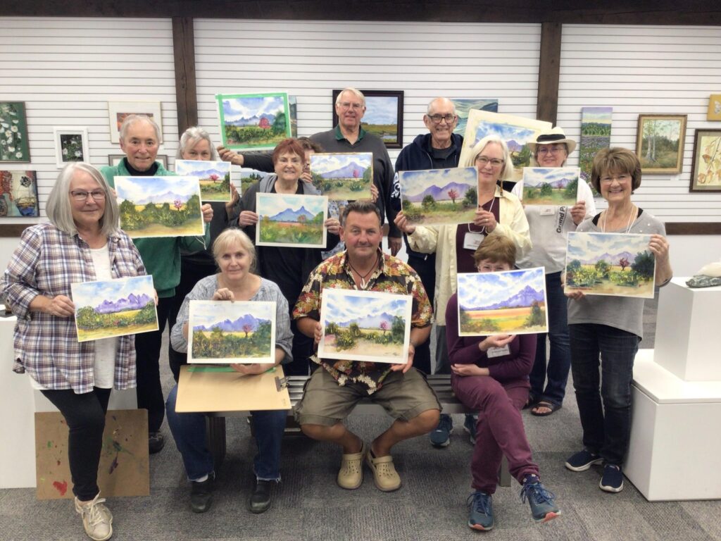 group of artists showing their paintings in studio | GPS: 49.283735, -122.520942