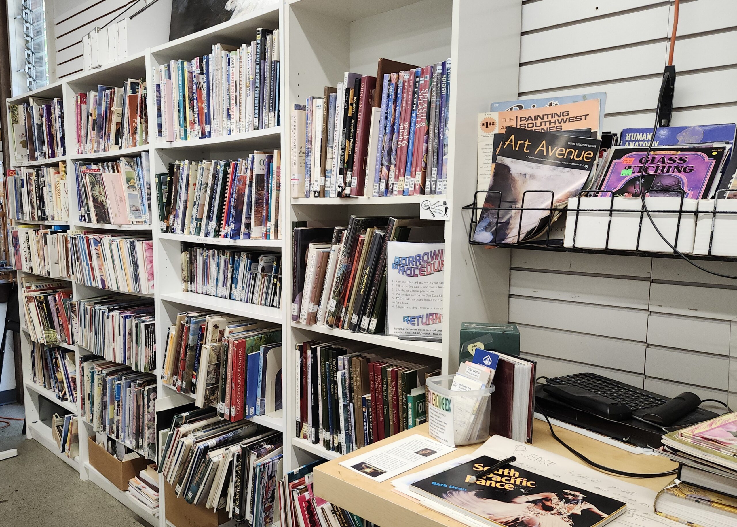 Shelves filled with art books and magazines inside a gallery library.