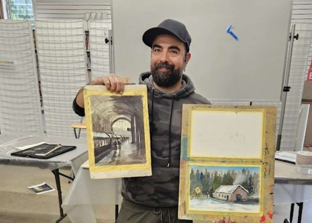 artistic-workshop-multiple-paintings-held-by-participant